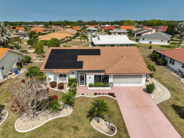 mediterranean / spanish-style home featuring a tile roof, an attached garage, driveway, and stucco siding