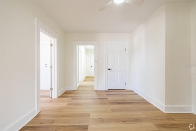 interior space featuring baseboards and light wood-style floors