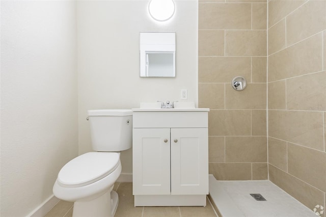 full bath with tiled shower, toilet, vanity, tile patterned flooring, and baseboards