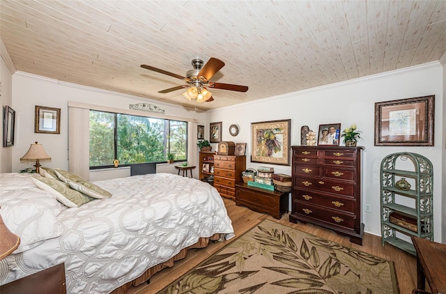 bedroom with wood finished floors, crown molding, and wood ceiling