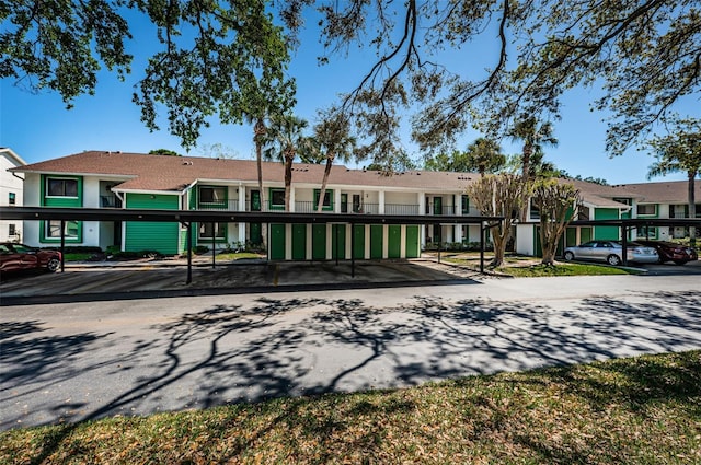 exterior space with stucco siding and covered parking