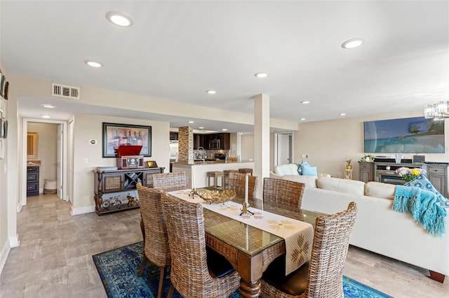 dining space featuring baseboards, visible vents, recessed lighting, and light wood finished floors