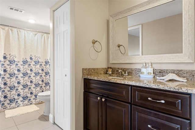 full bathroom with tile patterned flooring, vanity, toilet, visible vents, and a closet