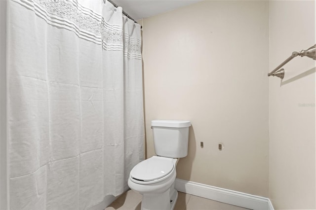 full bathroom featuring tile patterned floors, toilet, and baseboards