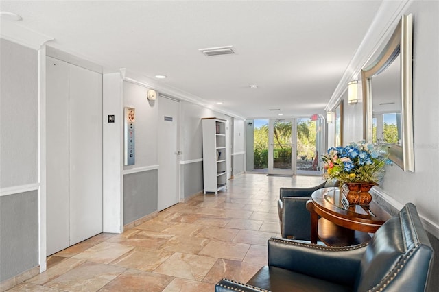corridor featuring elevator, visible vents, and ornamental molding
