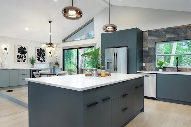 1320 Coral Way S, Saint Petersburg, FL 33705 - kitchen featuring stainless steel appliances, modern cabinets, light countertops, high vaulted ceiling, and plenty of natural light