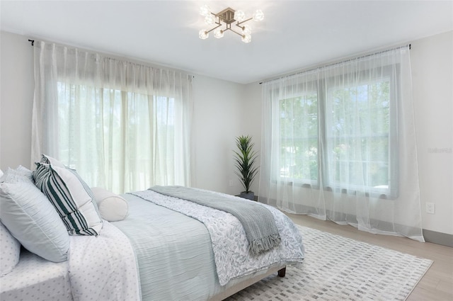 1320 Coral Way S, Saint Petersburg, FL 33705 - bedroom with wood finished floors and a chandelier