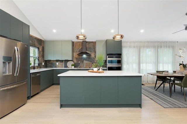 1320 Coral Way S, Saint Petersburg, FL 33705 - kitchen with stainless steel appliances, wall chimney range hood, light countertops, light wood finished floors, and vaulted ceiling
