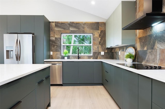 1320 Coral Way S, Saint Petersburg, FL 33705 - kitchen with wall chimney exhaust hood, appliances with stainless steel finishes, light countertops, gray cabinetry, and lofted ceiling