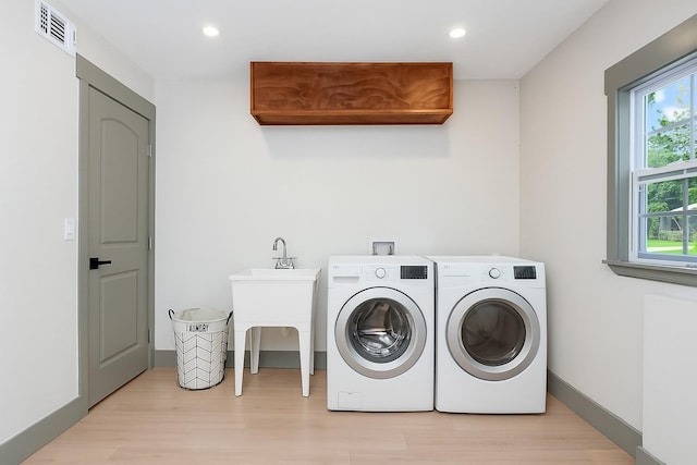 1320 Coral Way S, Saint Petersburg, FL 33705 - laundry room with light wood-type flooring, healthy amount of natural light, washing machine and dryer, and recessed lighting