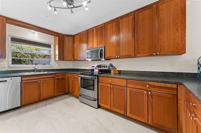 2700 Bayshore Blvd Unit 512, Dunedin, FL 34698 - kitchen with appliances with stainless steel finishes, a sink, and brown cabinetry