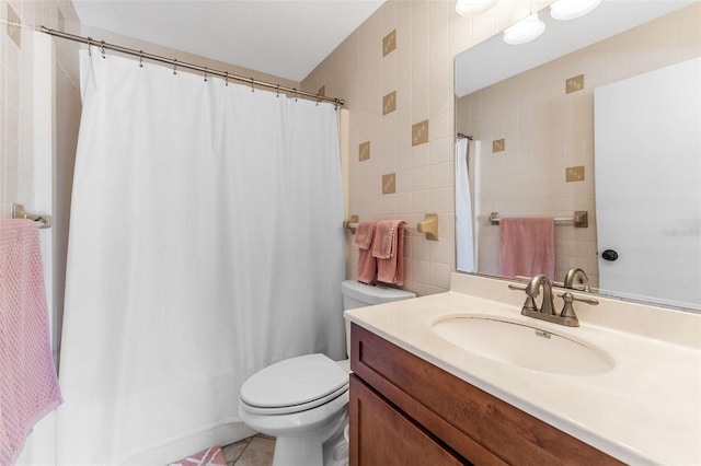 2700 Bayshore Blvd Unit 512, Dunedin, FL 34698 - full bathroom with tile walls, toilet, vanity, and tile patterned floors