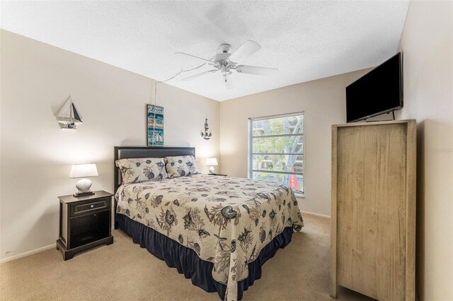2700 Bayshore Blvd Unit 512, Dunedin, FL 34698 - bedroom with light colored carpet, baseboards, a ceiling fan, and a textured ceiling