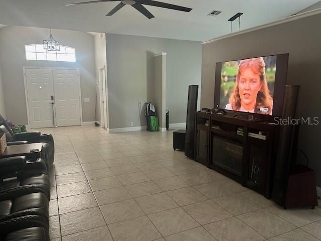 14305 Tennyson Dr, Hudson, FL 34667 - living room with a ceiling fan, baseboards, visible vents, and light tile patterned flooring