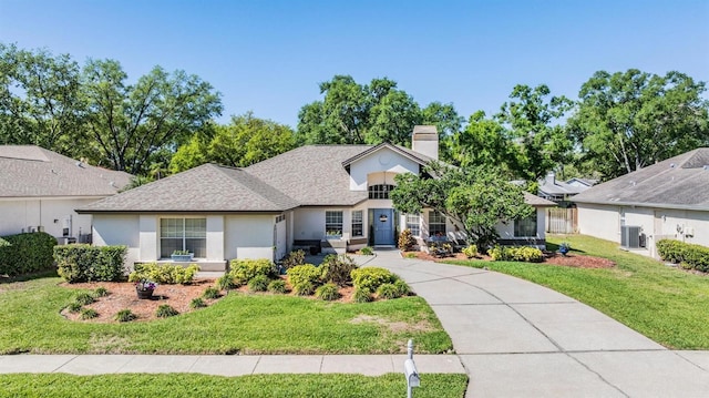 ranch-style home with a front lawn, concrete driveway, roof with shingles, stucco siding, and cooling unit