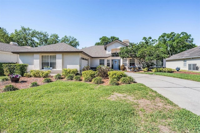 ranch-style house featuring a front yard, driveway, a shingled roof, stucco siding, and a garage