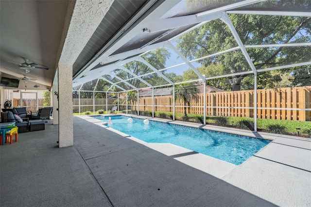 view of swimming pool with a fenced in pool, ceiling fan, glass enclosure, a fenced backyard, and a patio