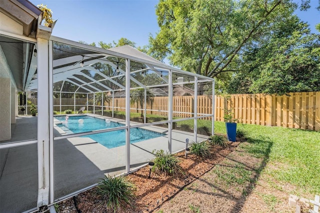 view of pool with a lanai, a fenced in pool, a fenced backyard, and a patio area
