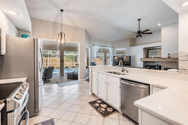 kitchen with a sink, light tile patterned floors, plenty of natural light, and stainless steel appliances
