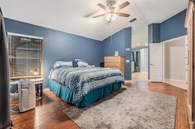 bedroom with visible vents, a textured ceiling, lofted ceiling, and wood-type flooring