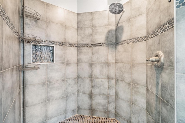 bathroom with a tile shower