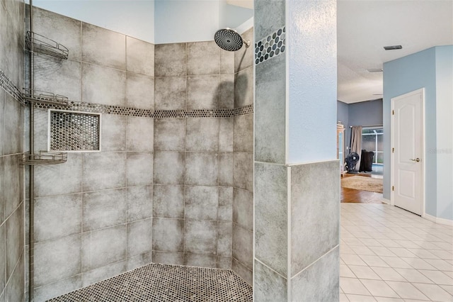 full bath featuring tile patterned floors and tiled shower