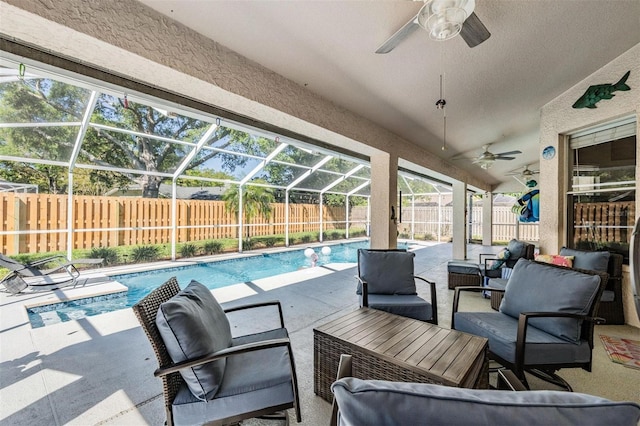 view of patio featuring glass enclosure, a fenced backyard, a fenced in pool, and ceiling fan