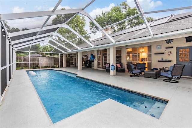 view of swimming pool with a fenced in pool, fence, glass enclosure, an outdoor hangout area, and a patio area