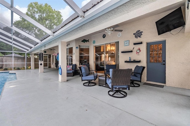 view of patio / terrace with glass enclosure, a fenced in pool, a ceiling fan, and fence