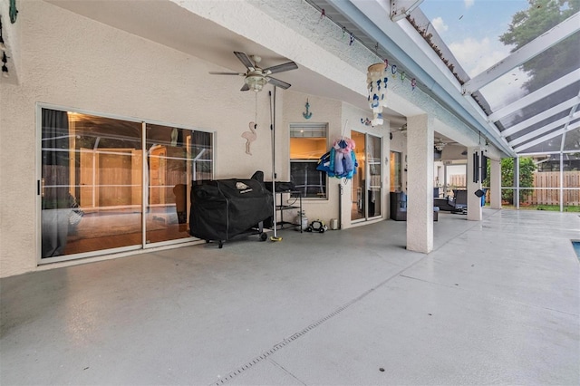 view of patio / terrace with a lanai, a grill, fence, and ceiling fan