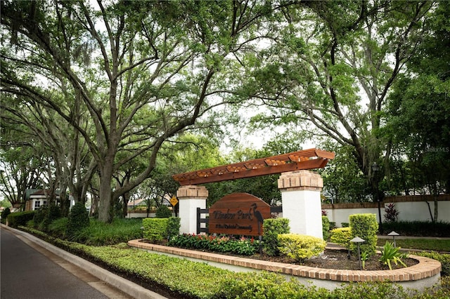 community sign featuring fence