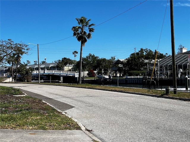 view of road with curbs and street lights