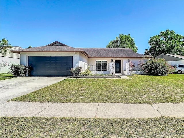 ranch-style home featuring stucco siding, a garage, concrete driveway, and a front yard