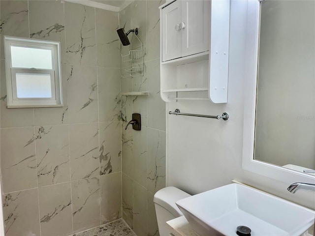 full bath with a sink, toilet, and a stall shower