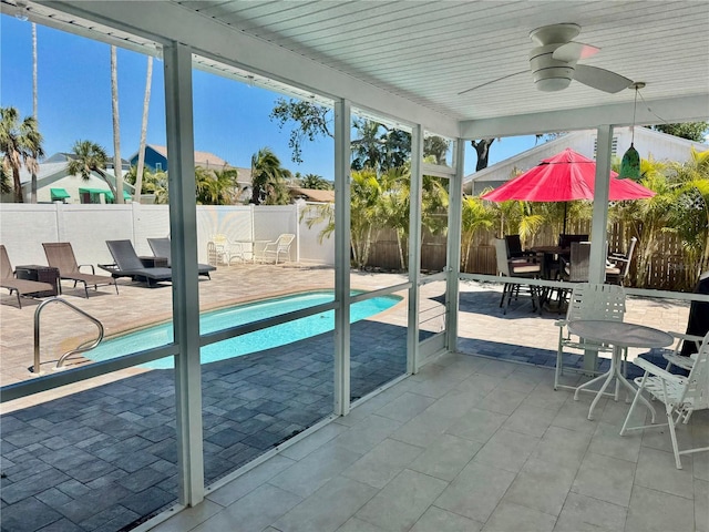 view of swimming pool with a ceiling fan, a fenced backyard, outdoor dining area, a fenced in pool, and a patio area