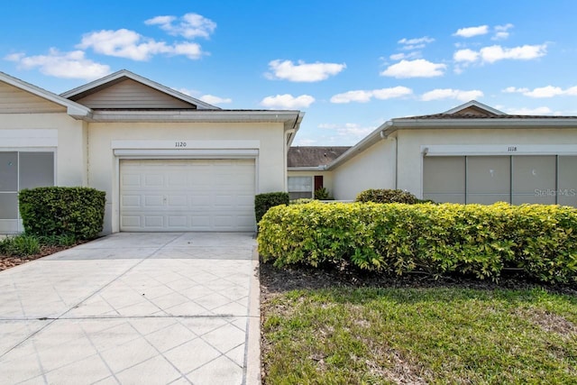 ranch-style home with driveway, a garage, and stucco siding