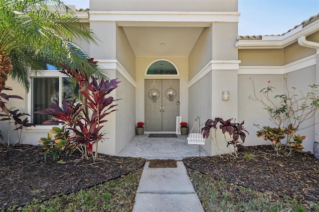 954 Cobblestone Ln, Tarpon Springs, FL 34688 - view of exterior entry with stucco siding