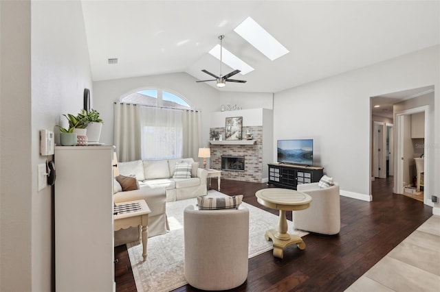954 Cobblestone Ln, Tarpon Springs, FL 34688 - living area featuring visible vents, a fireplace, lofted ceiling with skylight, wood finished floors, and a ceiling fan