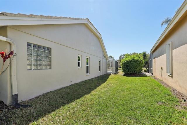 954 Cobblestone Ln, Tarpon Springs, FL 34688 - view of side of property featuring stucco siding and a yard