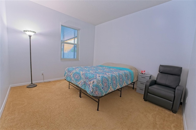 carpeted bedroom featuring baseboards