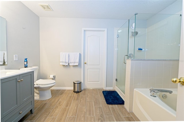 bathroom with vanity, wood finish floors, a stall shower, visible vents, and a bath