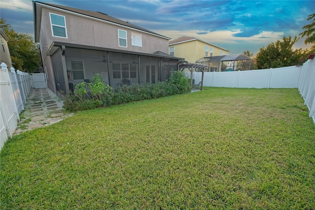view of yard featuring a fenced backyard and a sunroom