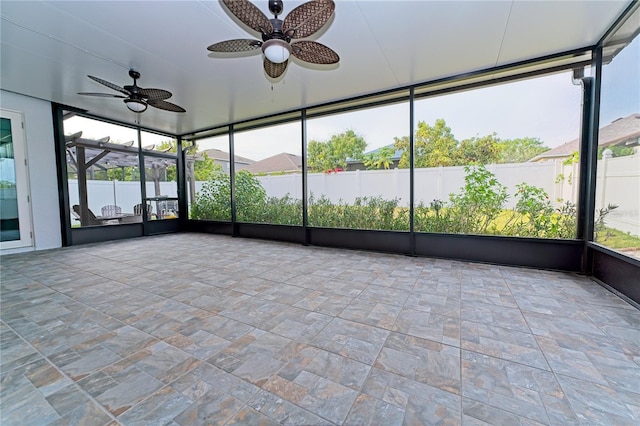 unfurnished sunroom featuring ceiling fan