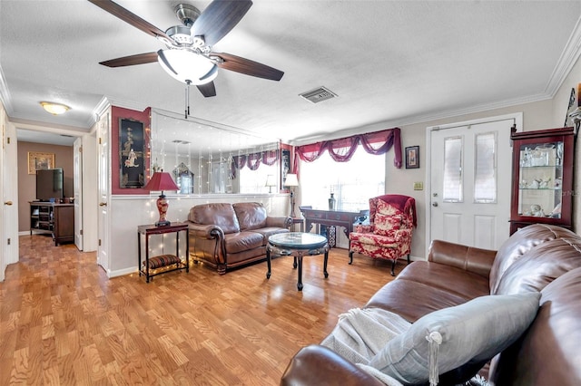 10035 Cherry Creek Ln, Port Richey, FL 34668 - living area featuring visible vents, ceiling fan, ornamental molding, light wood-style floors, and a textured ceiling
