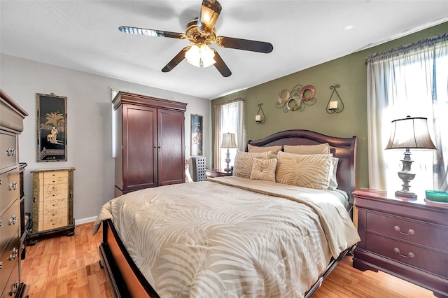 10035 Cherry Creek Ln, Port Richey, FL 34668 - bedroom featuring light wood-style flooring, a ceiling fan, and baseboards