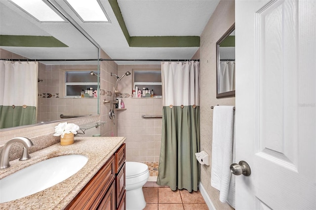 10035 Cherry Creek Ln, Port Richey, FL 34668 - bathroom with tile patterned flooring, toilet, vanity, and tiled shower
