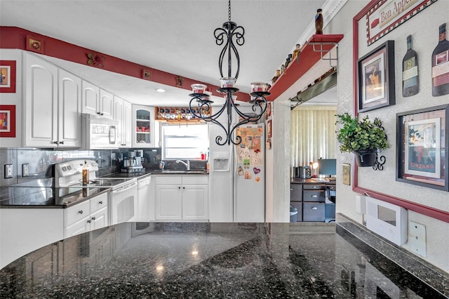10035 Cherry Creek Ln, Port Richey, FL 34668 - kitchen featuring a notable chandelier, tasteful backsplash, white cabinetry, white appliances, and glass insert cabinets