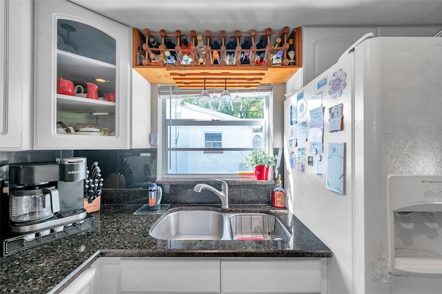 10035 Cherry Creek Ln, Port Richey, FL 34668 - kitchen with a sink, white cabinets, glass insert cabinets, and white fridge with ice dispenser