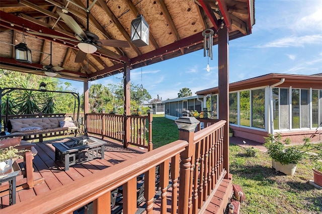 10035 Cherry Creek Ln, Port Richey, FL 34668 - deck with an outdoor hangout area, ceiling fan, and a sunroom
