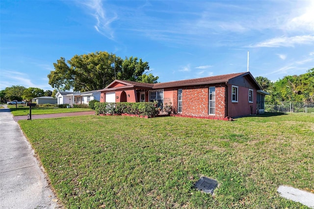 10035 Cherry Creek Ln, Port Richey, FL 34668 - ranch-style house featuring stucco siding, concrete driveway, a front lawn, and fence